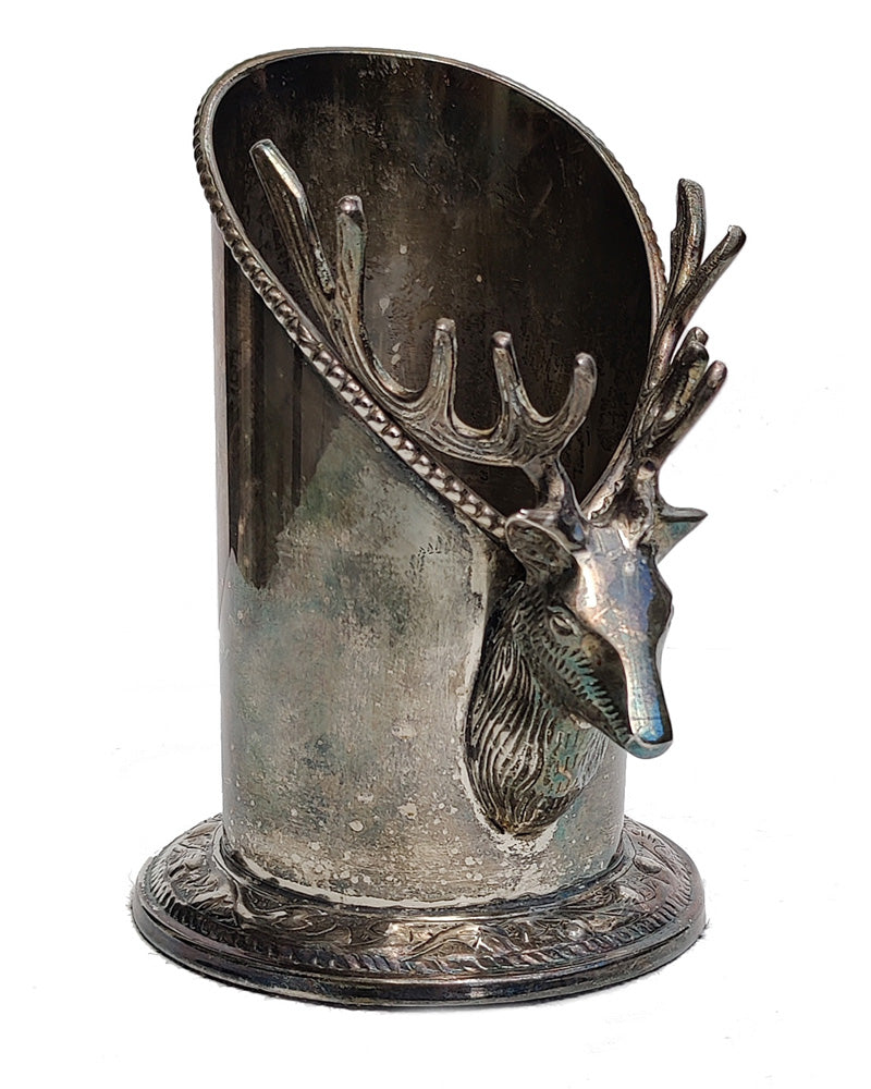 A silver vintage wine of champagne bottle holder with a stag head detail 