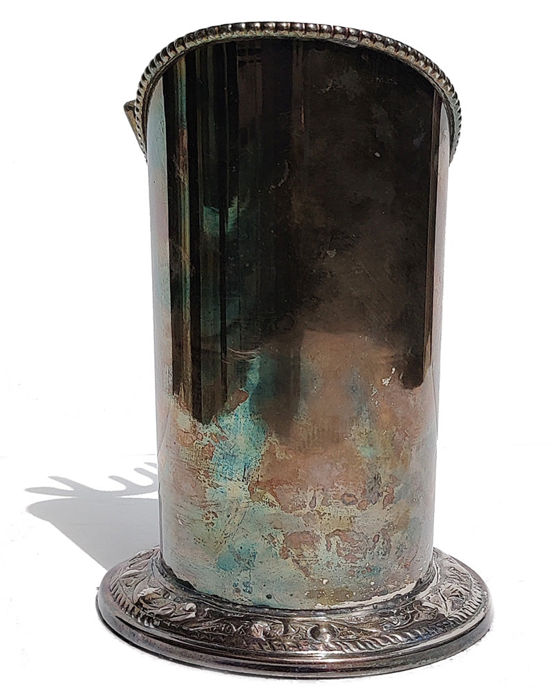 A silver vintage wine of champagne bottle holder with a stag head detail back