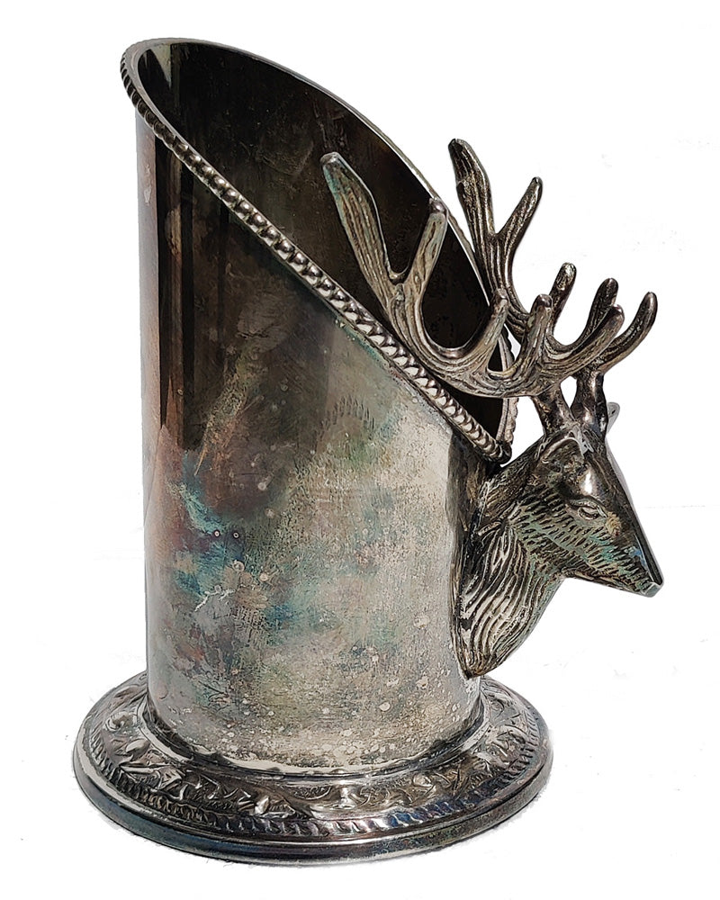 A silver vintage wine of champagne bottle holder with a stag head detail side view