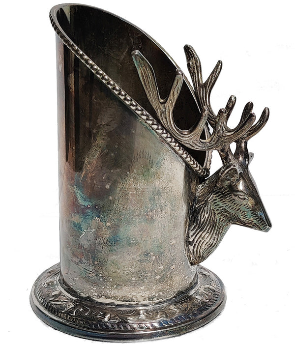 A silver vintage wine of champagne bottle holder with a stag head detail bottom